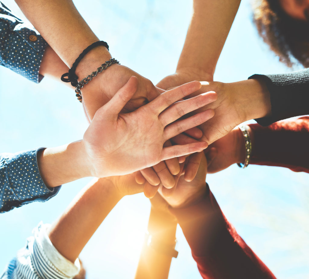 group of people putting their hands together