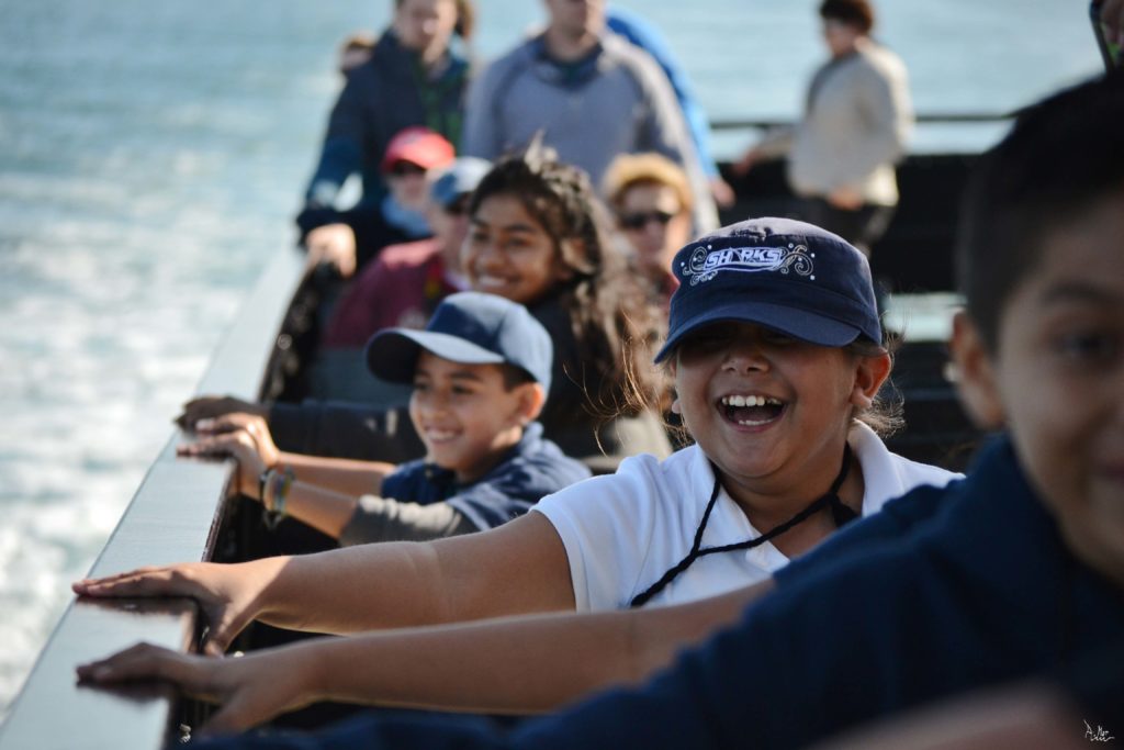 Ocean Literacy: Young girl smiling wearing a shark hat